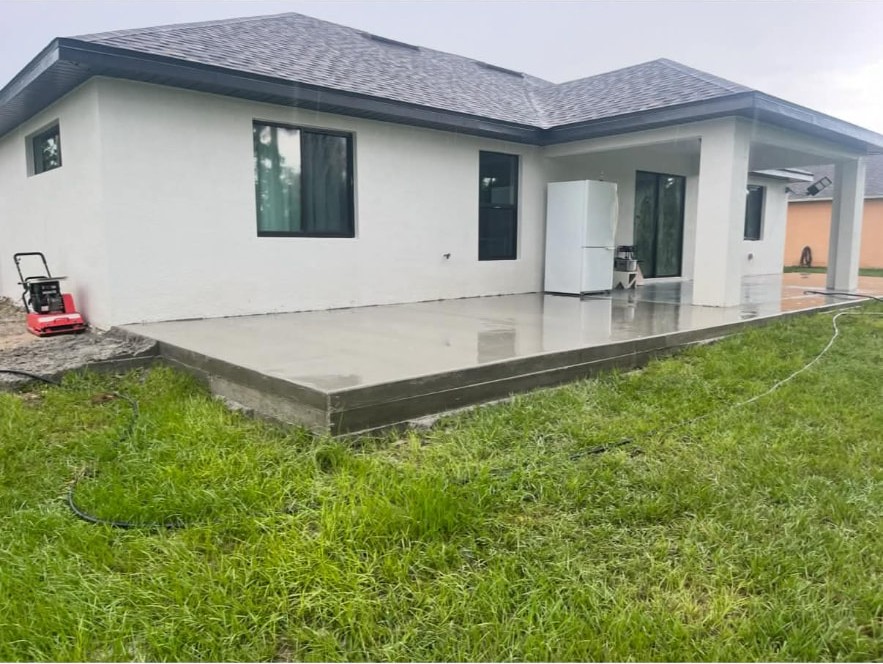 Wet-finished patio slab behind a new build