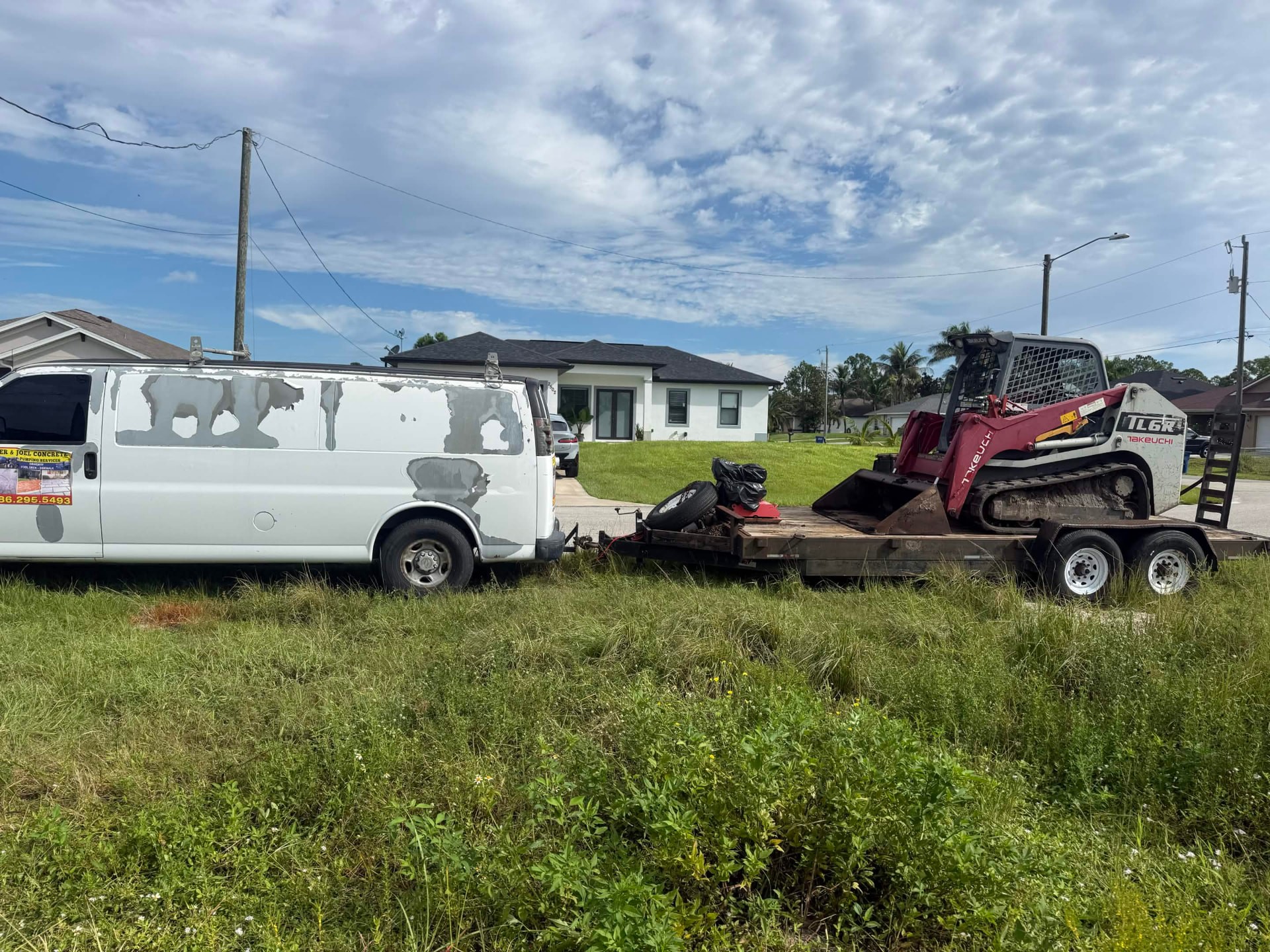 Work van and Takeuchi track loader loaded on the trailer